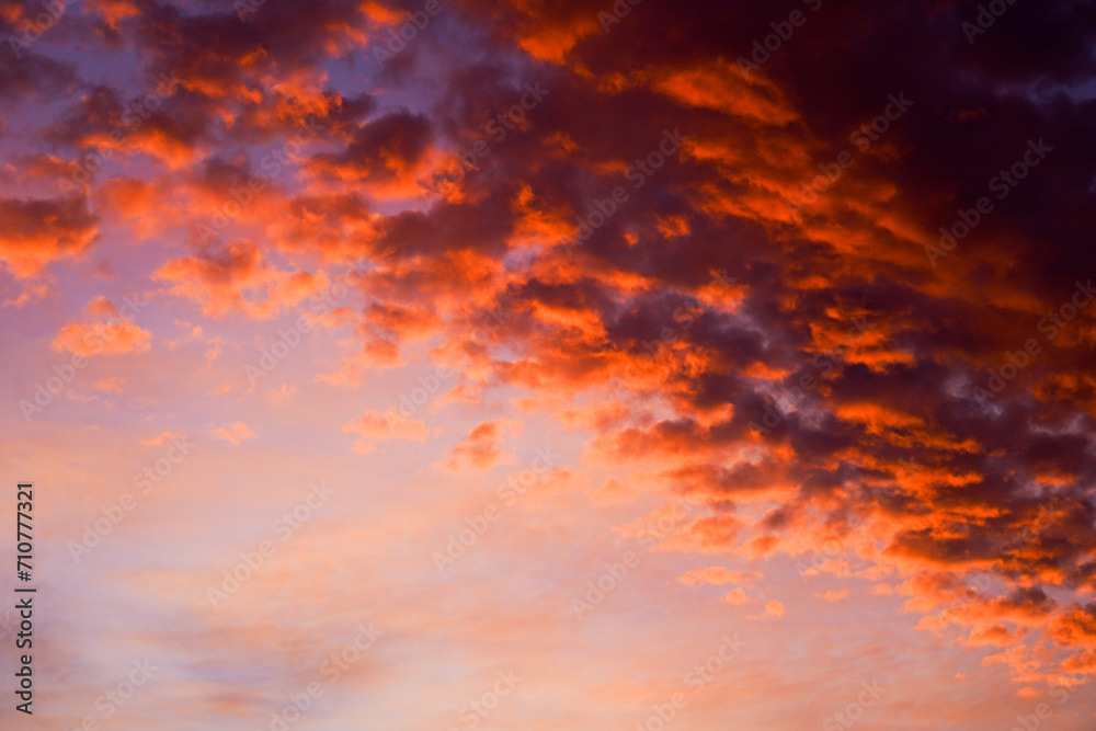 Sticker Vivid clouds illuminated by the sunset in a gradient sky