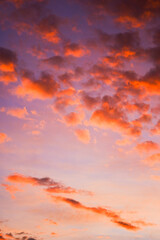 Sky adorned with streaks of orange clouds during sunset.