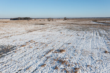 Fields, meadows and pasture covered with snow in winter in Poland. Winter rural landscape.