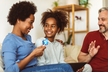 Family Using Digital Tablet And Credit Card At Home