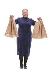 Mature woman with shopping bags, smiling at camera