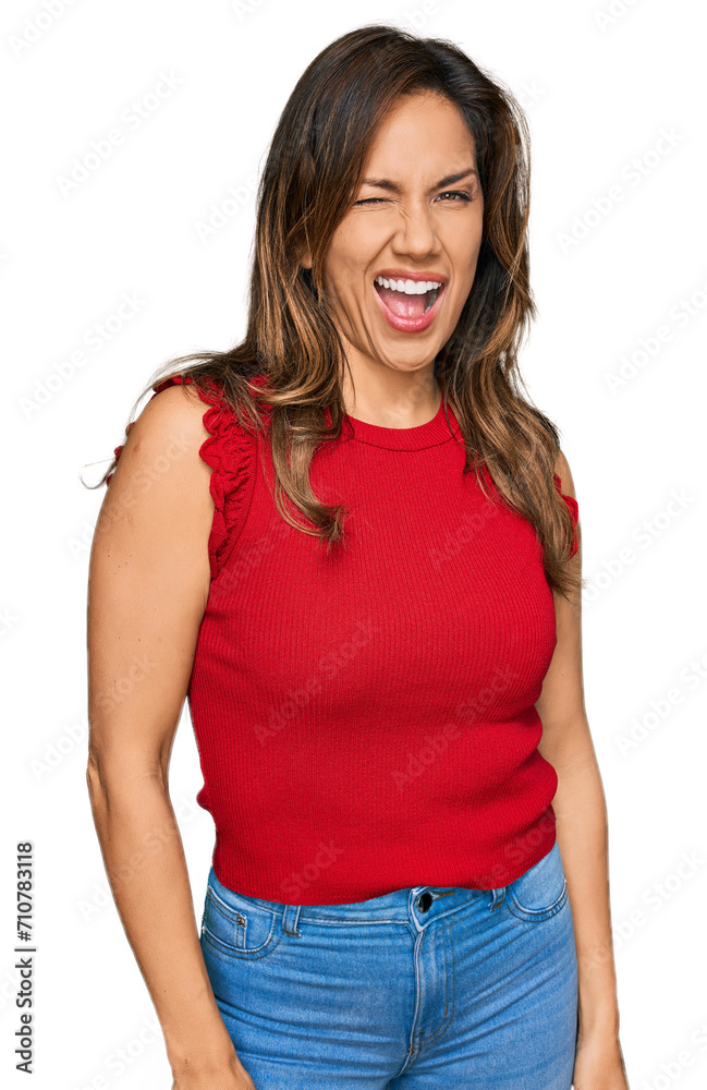 Sticker young hispanic woman wearing casual clothes winking looking at the camera with sexy expression, chee