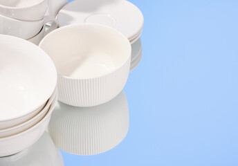 Modern dinnerware on the mirror. Copy space for text.