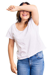 Fototapeta premium Young beautiful caucasian woman wearing casual white tshirt covering eyes with arm smiling cheerful and funny. blind concept.