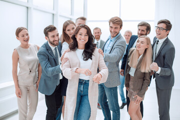 happy business team admiring their young leader