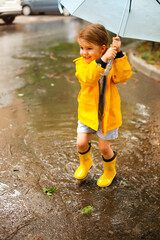 Little girl under umbrella in rainy day