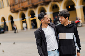 Young father and his son strolling through the city. Father's Day concept.......