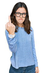 Young beautiful woman wearing casual clothes and glasses showing middle finger, impolite and rude...