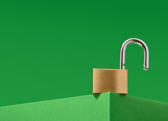 An open gold shining lock on a green background. Minimalistic savings concept.