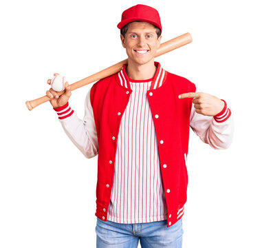 Young handsome man playing baseball holding bat and ball pointing finger to one self smiling happy and proud