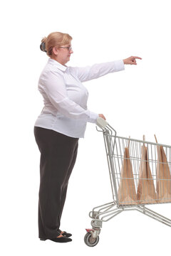 Full Length Portrait Of A Woman Pushing A Shopping Trolley