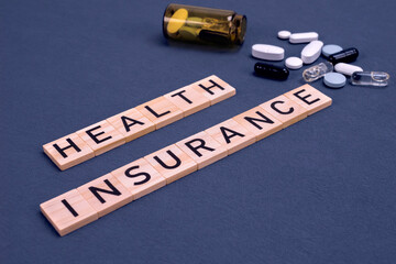 Health insurance concept with pills on gray background