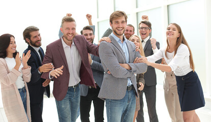 smiling entrepreneur on the background of jubilant business team