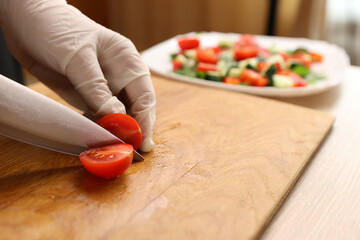 Tomatoes are added to bread with cheese and a piece of salmon. Preparation of canapes with fish and...
