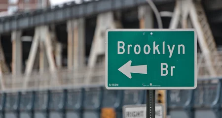 Velvet curtains Brooklyn Bridge brooklyn bridge sign on the side of the road in downtown brooklyn, new york city (famous landmark travel destination signage in nyc) isolated close up out of focus manhattan bridge background