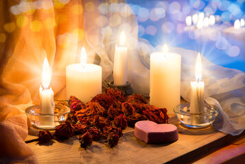 Candles and dried rosebuds on the table