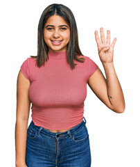 Young hispanic girl wearing casual t shirt showing and pointing up with fingers number four while smiling confident and happy.