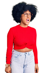 Young african american girl wearing casual clothes and glasses angry and mad screaming frustrated and furious, shouting with anger. rage and aggressive concept.