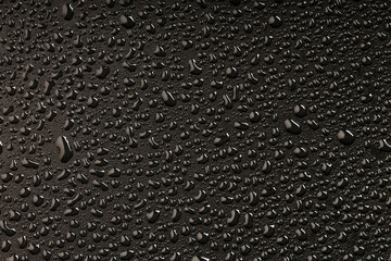 top view of water droplets on a plastic black background