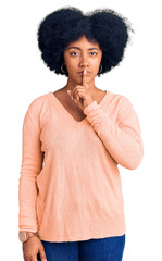 Young african american girl wearing casual clothes asking to be quiet with finger on lips. silence and secret concept.