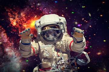 Fototapeta premium Astronaut surfing dark space. Planets, stars. Space scene. The elements of this image furnished by NASA.