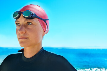 Swimmer sport, face and woman at ocean outdoor in summer for exercise, thinking of training or...