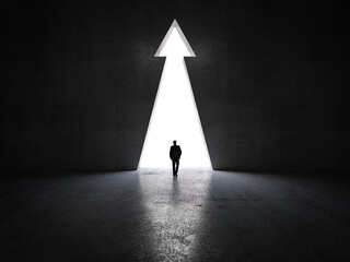 man walks towards an arrow-shaped exit.