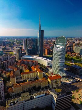 Aerial view of modern stylish cityscape of business skyscrapers. unicredit tower and UnipolSai, Microsoft Italia. Skyline. Drone. Sunny day and blue sky. Fashion city. Europe Italy Milan 01.2024