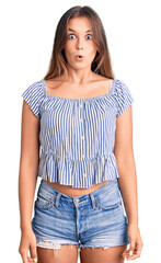 Obraz premium Beautiful caucasian woman wearing casual clothes scared and amazed with open mouth for surprise, disbelief face