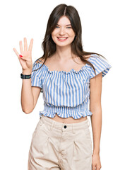 Young beautiful caucasian girl wearing casual clothes showing and pointing up with fingers number four while smiling confident and happy.