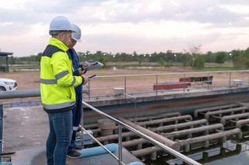 Environmental engineers work at wastewater treatment plants,Water supply engineering working at Water recycling plant for reuse,Technicians and engineers discuss work together.