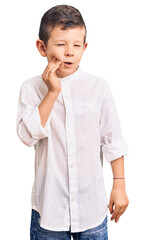 Cute blond kid wearing elegant shirt touching mouth with hand with painful expression because of toothache or dental illness on teeth. dentist