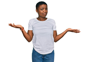 Young african american woman wearing casual white t shirt clueless and confused with open arms, no...