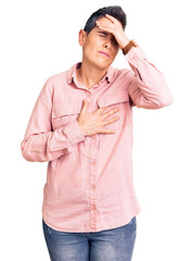 Young woman with short hair wearing casual clothes touching forehead for illness and fever, flu and cold, virus sick