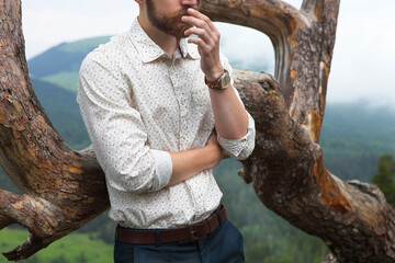 Hipster groom on top of the mountain