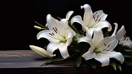 white lily flowers on a wooden table on a dark background
