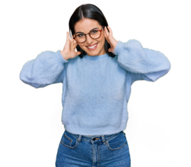 Young hispanic woman wearing casual clothes and glasses covering ears with fingers with annoyed expression for the noise of loud music. deaf concept.