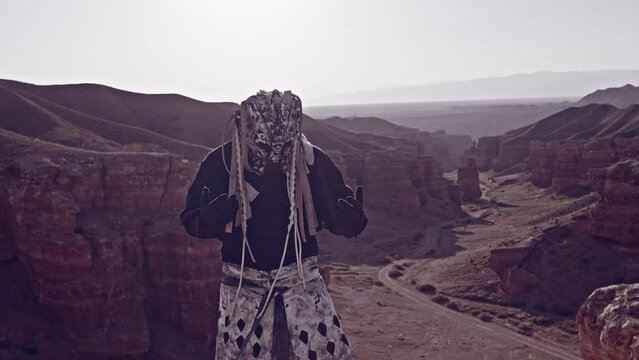 A masked shaman at the top of the canyon./ A masked shaman at the top of the canyon.
