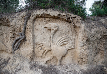 outdoor sculpted figure of a stork bird on the wall by anonymous sculptor in Falces Navarra