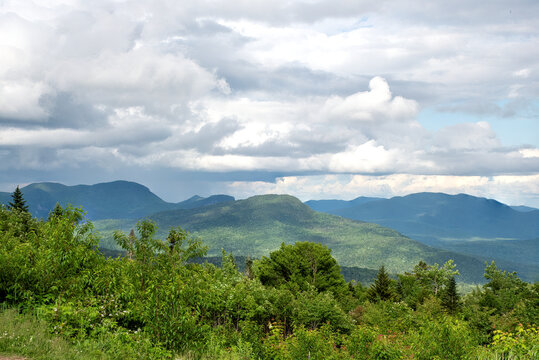 View from scenic overlook along the Kancamagus Highway in New Hampshire. Threatening storm clouds gathering over mountains in the White Mountain National Forest.