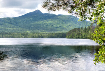 Scenic Lake Chocorua and prominent summit of rugged Mount Chocorua in White Mountains of New...