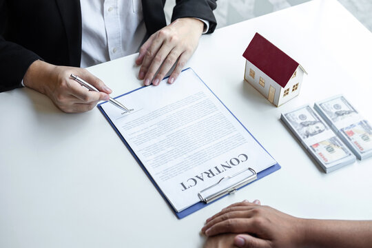 Estate agent broker reach contract form and presentation to client signing agreement contract real estate with approved mortgage application form, buying mortgage loan offer for and house insurance