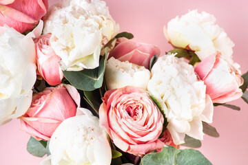 Background of flowers close-up, roses, white peonies, eucalyptus, holiday greetings.