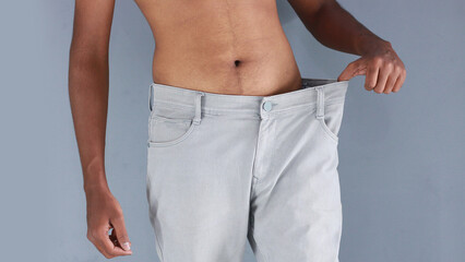 Indian man with weight loss body showing his big pants