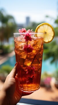 Hand holding a glass of iced hibiscus tea UHD wallpaper