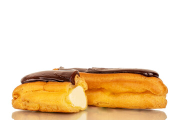 One whole and one half delicious chocolate eclair, close-up isolated on white.