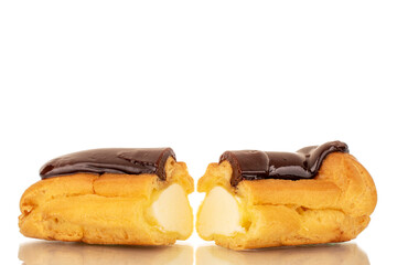 Two halves of a delicious chocolate eclair, close-up isolated on white.