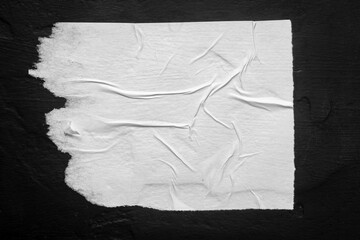White torn poster with folds.
