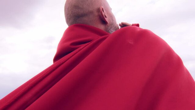 A monk in red prays in the steppe. A divine ritual.