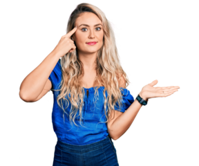 Young blonde woman wearing casual clothes confused and annoyed with open palm showing copy space and pointing finger to forehead. think about it.